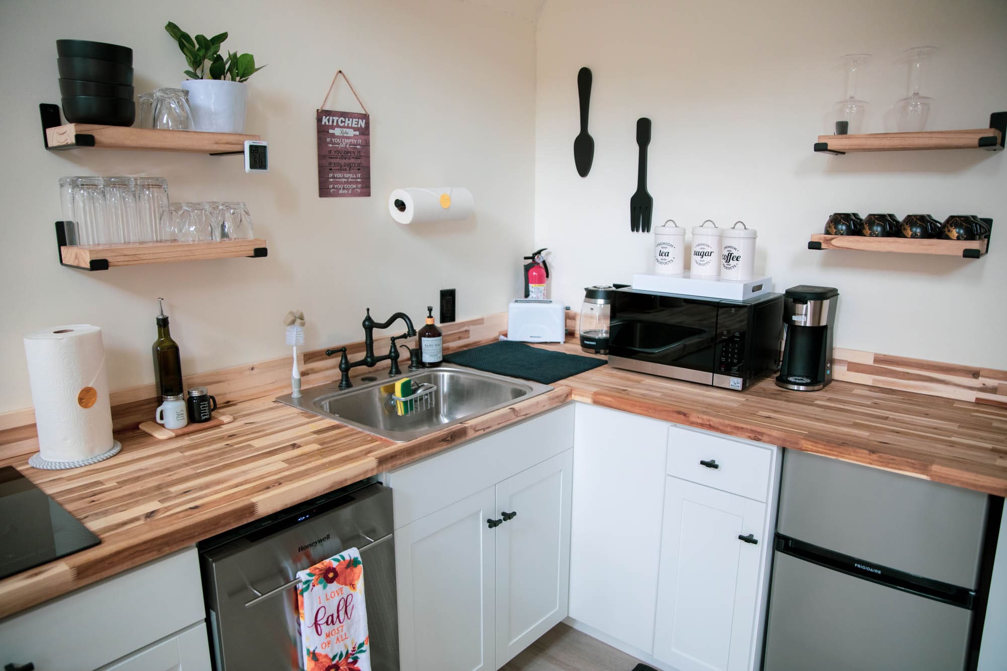 Stocked coffee bar with vintage tea, sugar, and coffee canisters inside Bella Casa A-Frame cabin